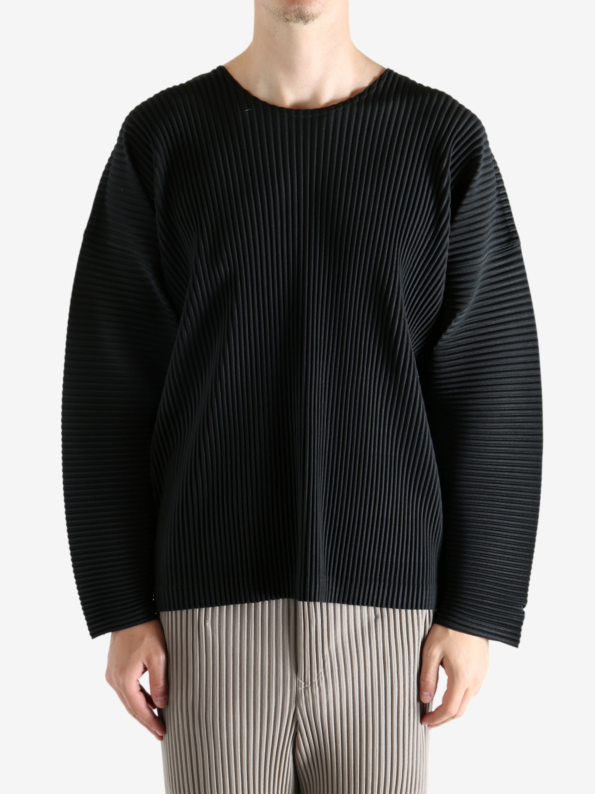 Black t-shirt worn by a person, showing the shirt's fit