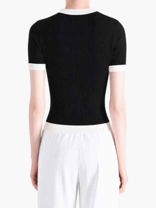 Black shirt worn by a person, showing the shirt fit