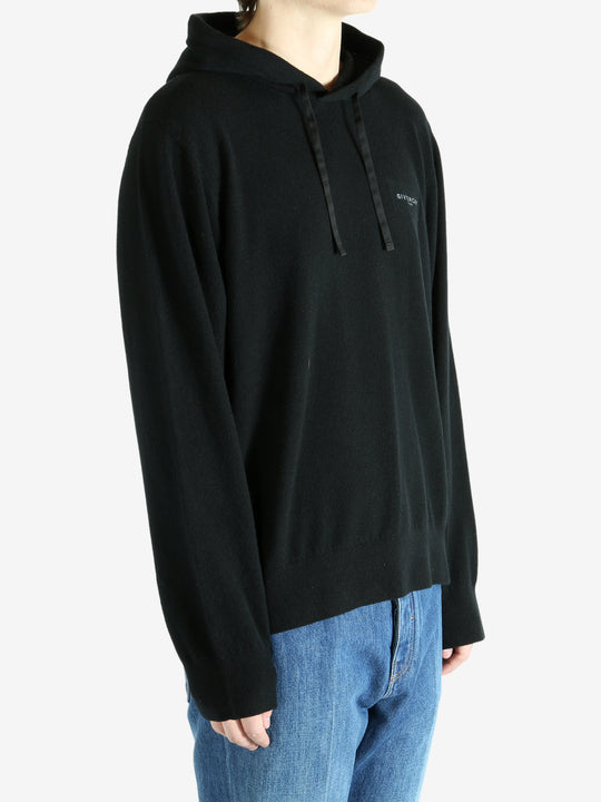 Black hoodie worn by a person, showing the hoodie's fit