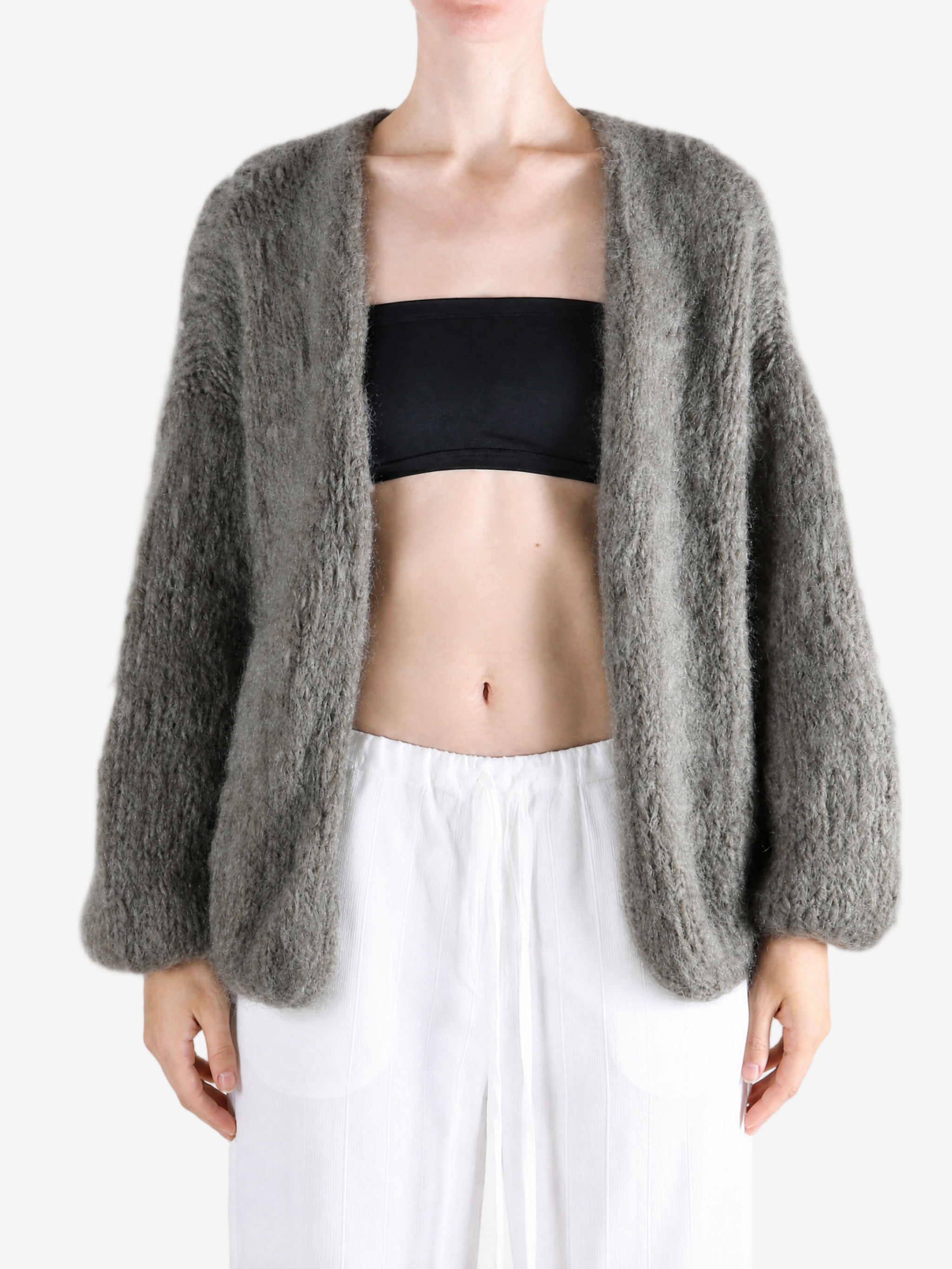 Grey knitwear worn by a person, showing the knitwear fit