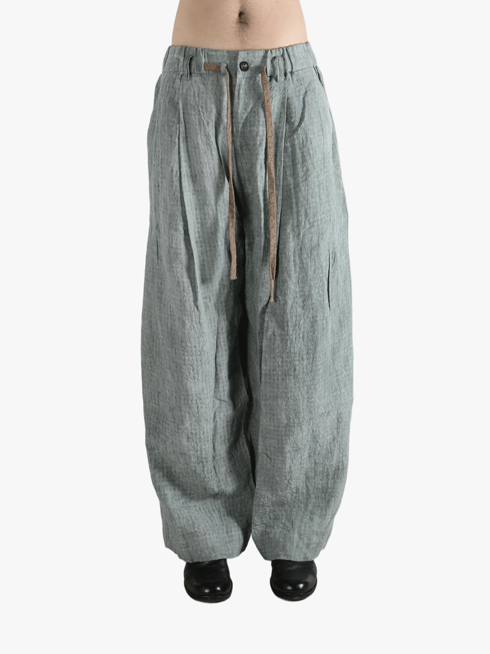 Gray pants worn by a person, showing the pants fit