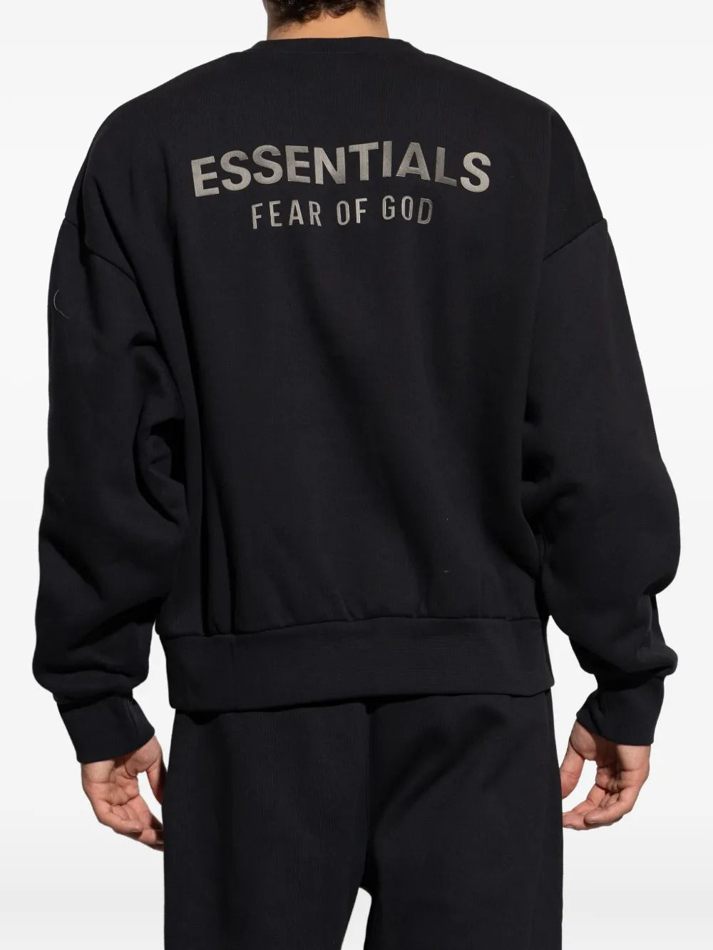 Black sweatshirt worn by a person, showing the sweatshirt's fit