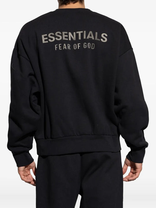 Black sweatshirt worn by a person, showing the sweatshirt's fit