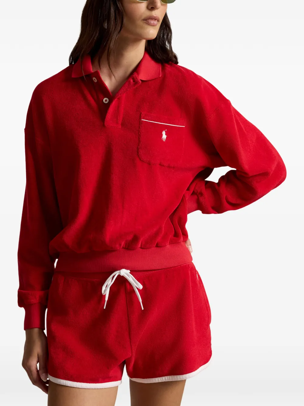 Red knitwear worn by a person, showing the knitwear fit