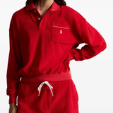 Red knitwear worn by a person, showing the knitwear fit