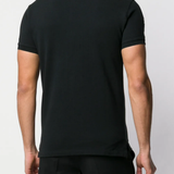Black shirts worn by a person, showing the shirts fit