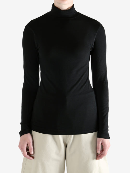 Black t-shirt worn by a person, showing the shirt's fit