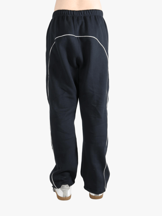 Black pants worn by a person, showing the pants fit