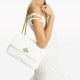 White bag carried by a person, showing the bag’s fit