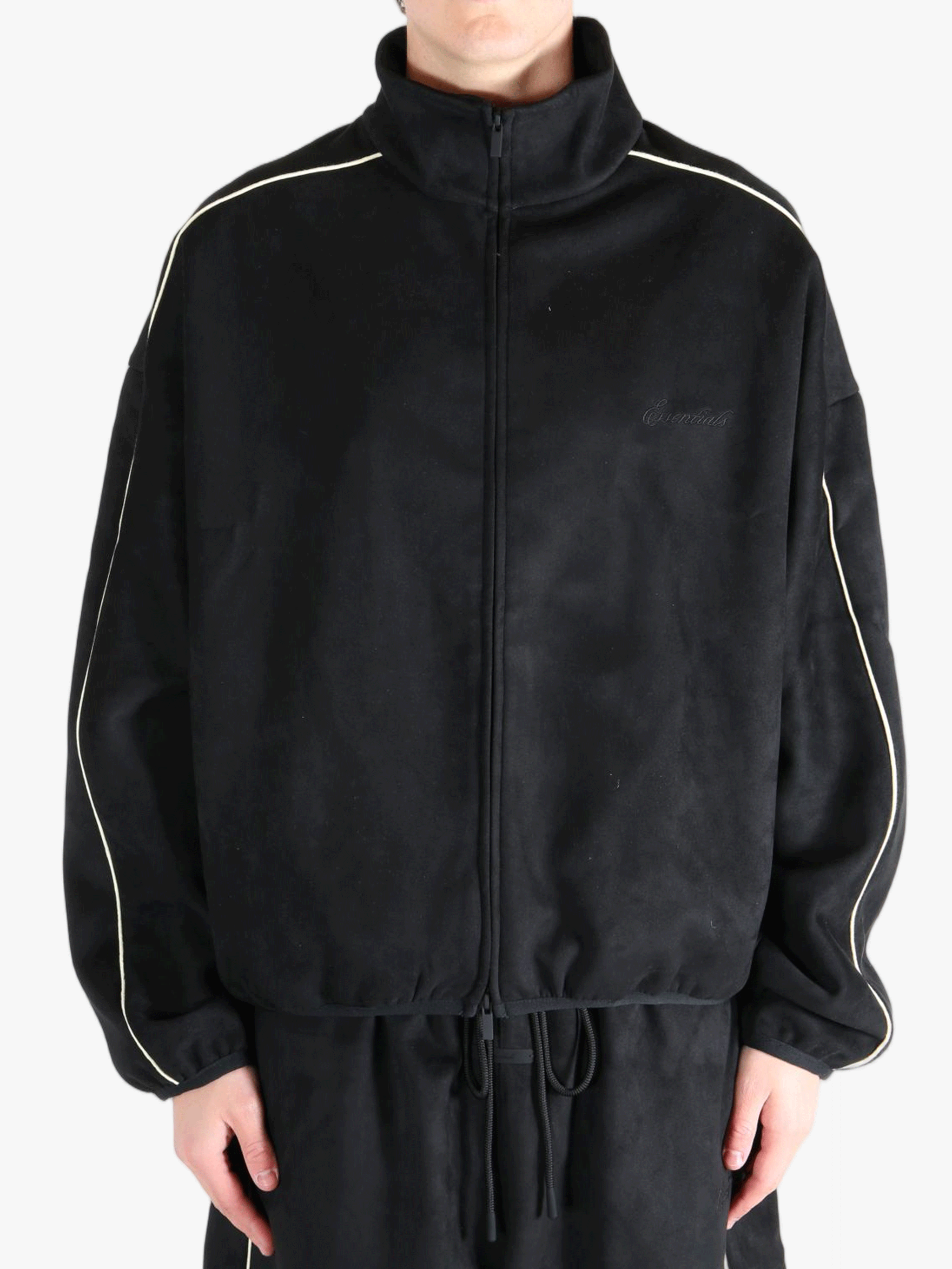 Black jacket worn by a person, showing the jacket's fit