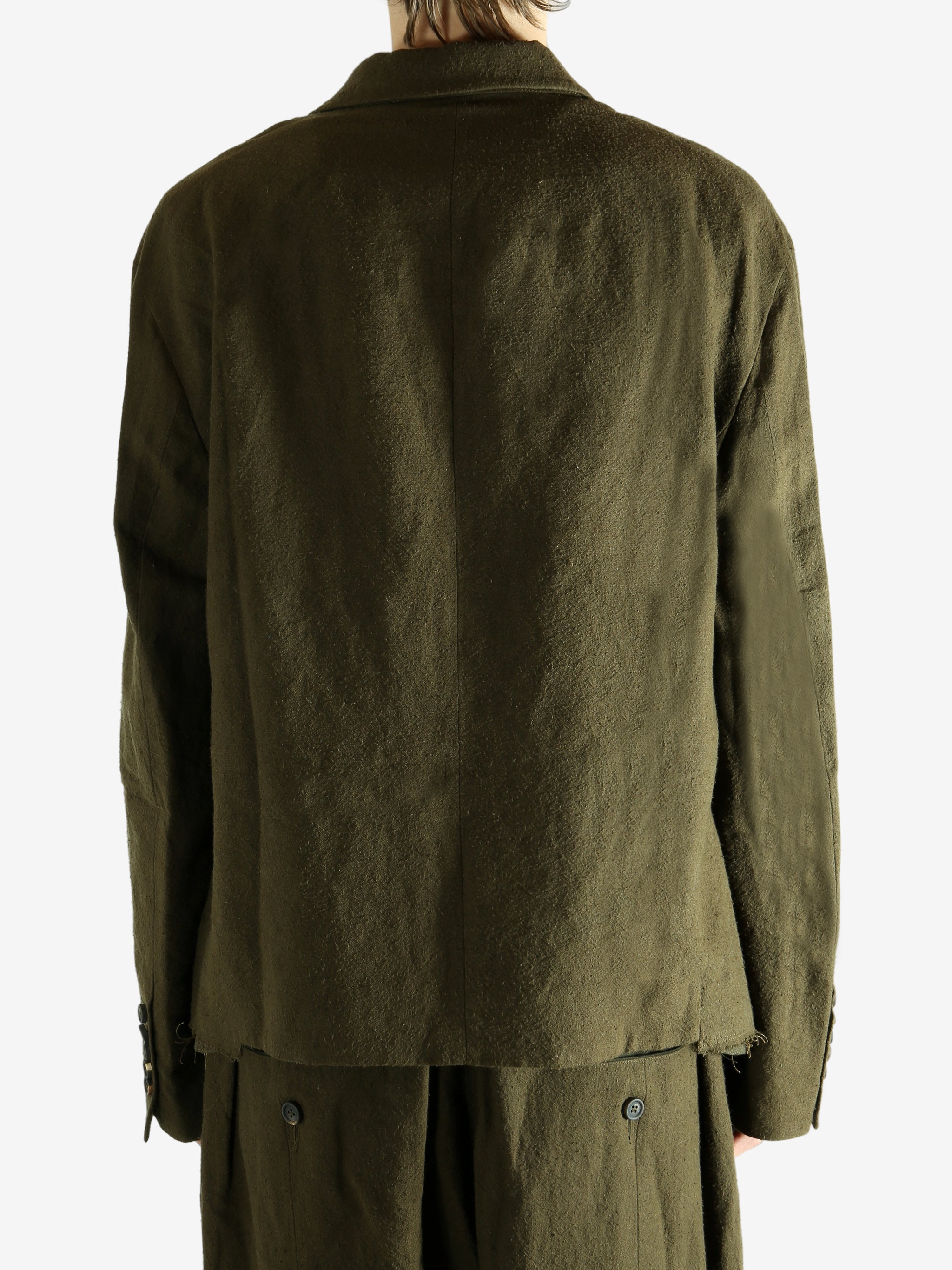 Green blazer worn by a person, showing the blazer's fit