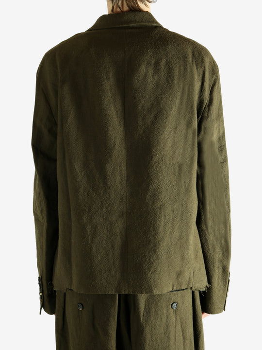 Green blazer worn by a person, showing the blazer's fit