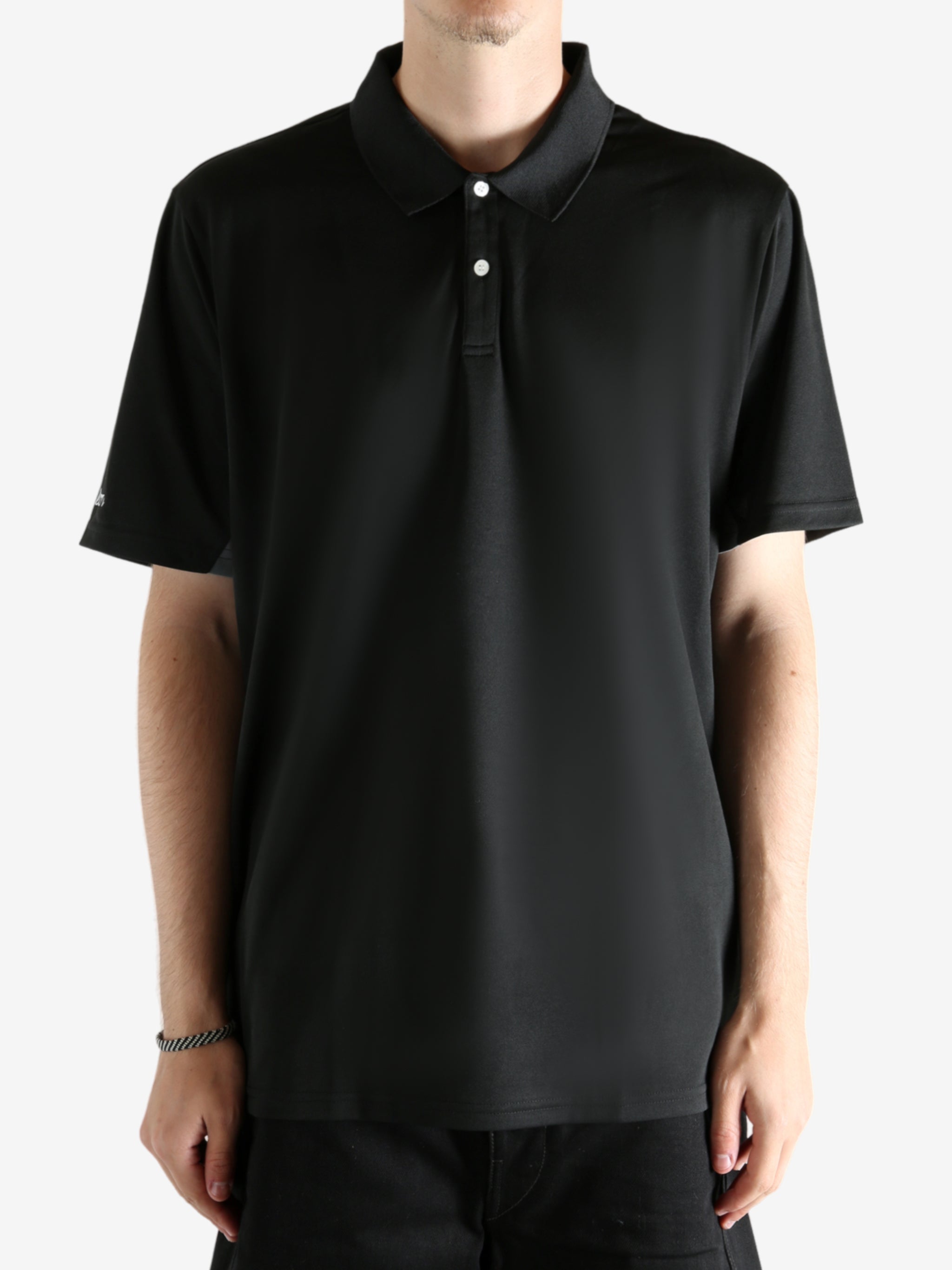 Black shirt worn by a person, showing the shirt's fit
