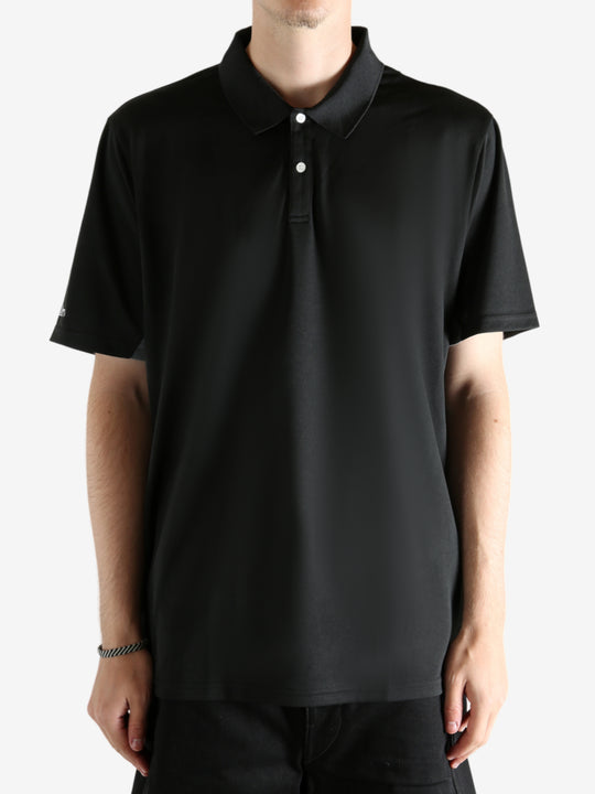 Black shirt worn by a person, showing the shirt's fit