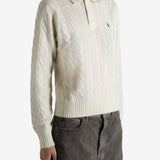 White sweater worn by a person, showing the sweater's fit