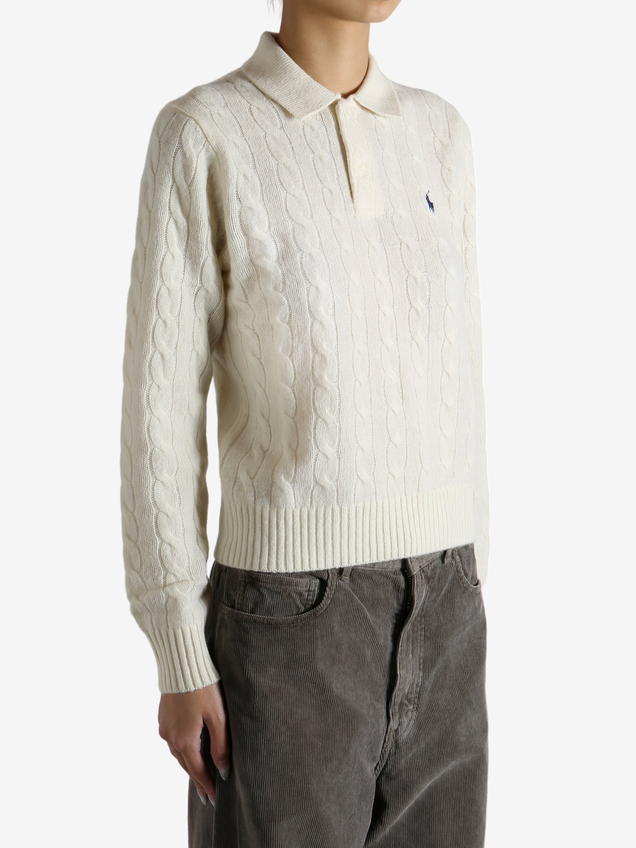 White sweater worn by a person, showing the sweater's fit