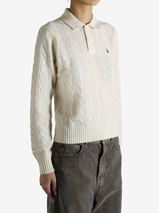 White sweater worn by a person, showing the sweater's fit