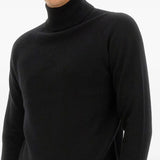 Close up of black knitwear, showing texture of the viscose fabric