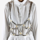 White top worn by a person, showing the top's fit