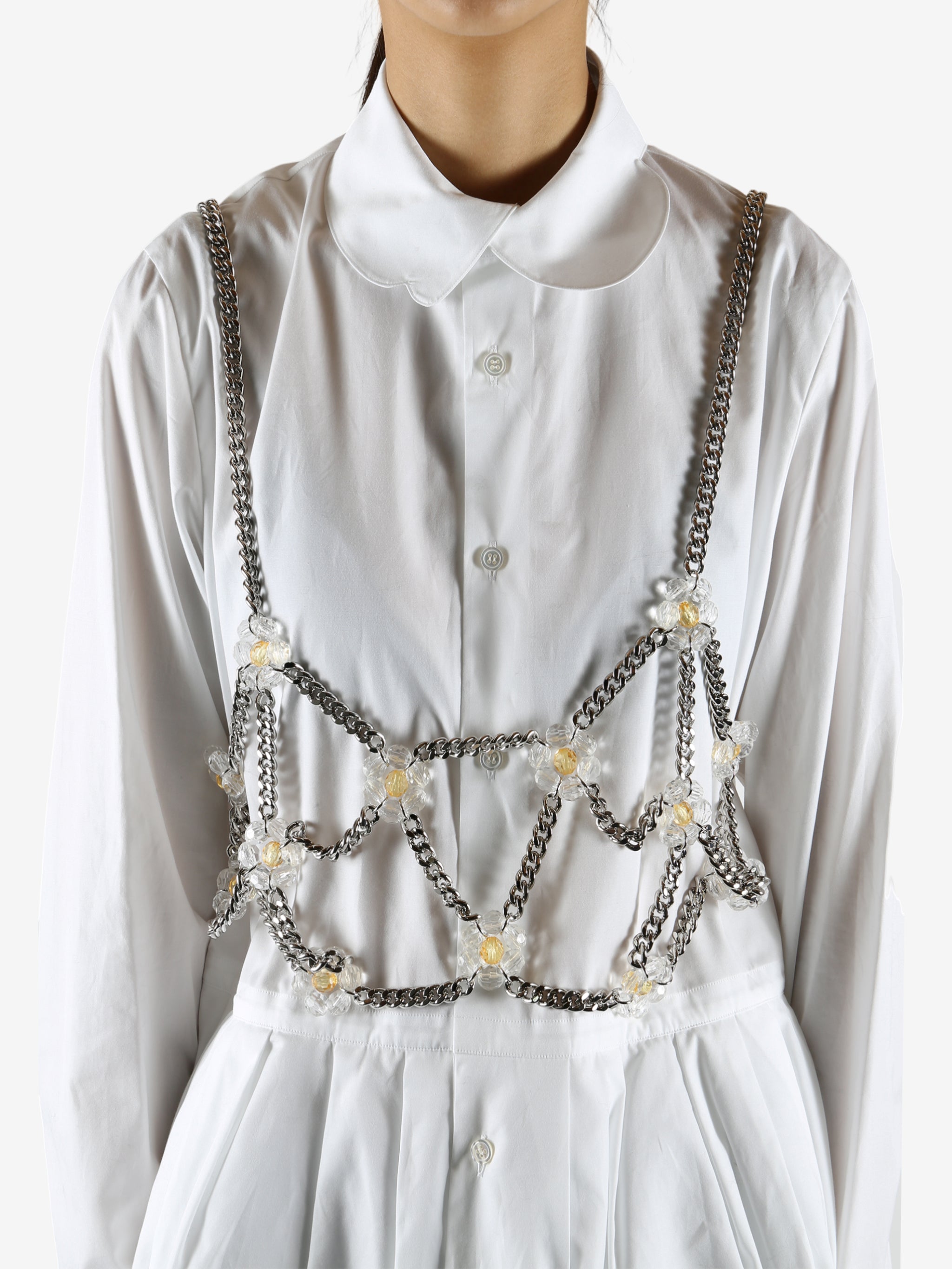 White top worn by a person, showing the top's fit