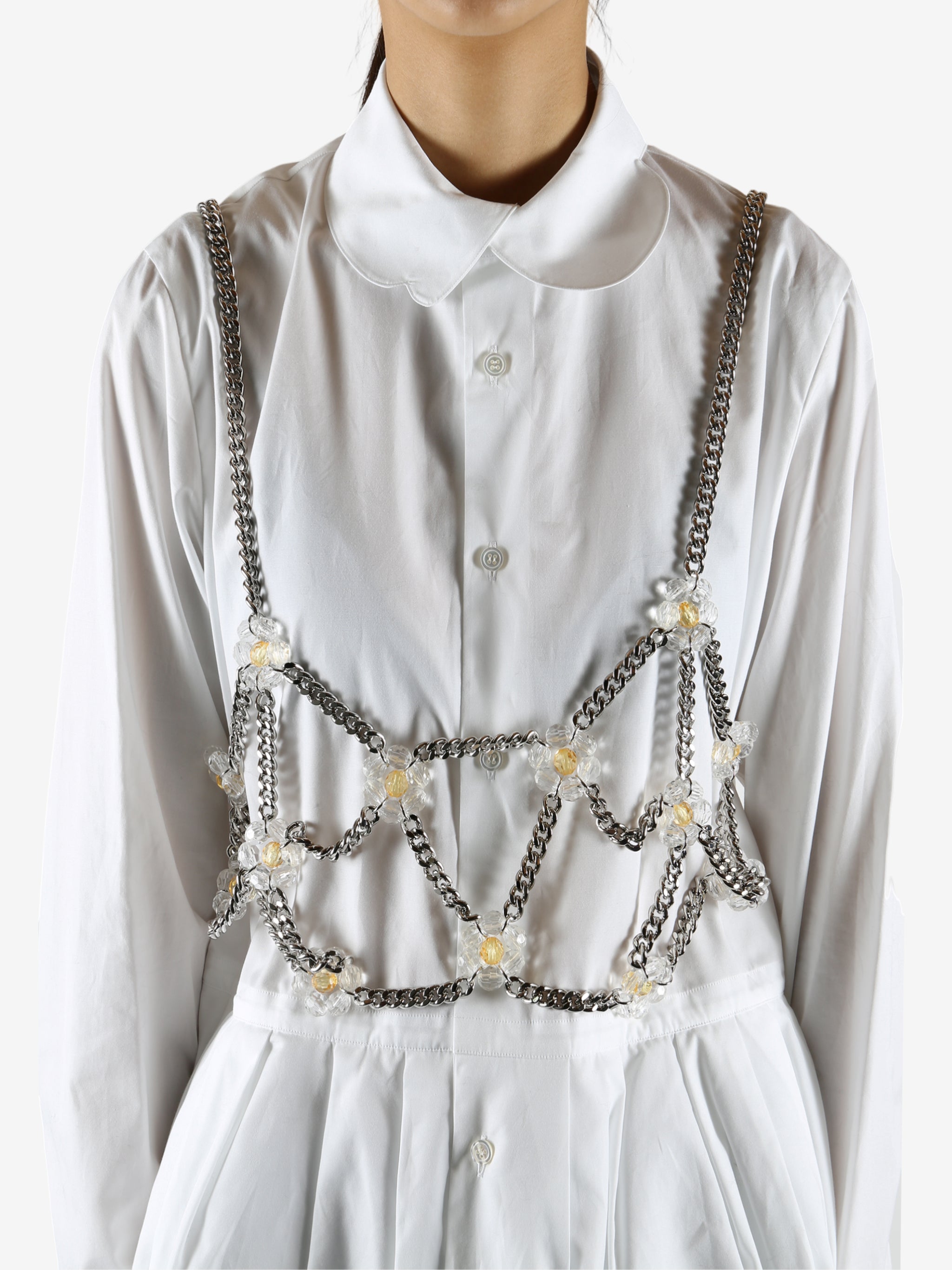 White top worn by a person, showing the top's fit