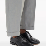 Black shoes worn by a person, showing the shoes's fit