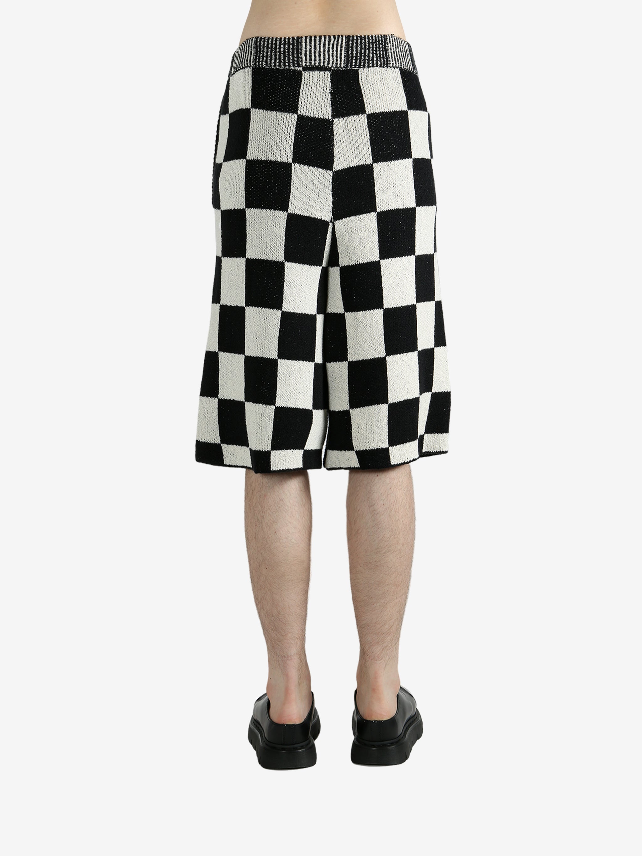 Black shorts worn by a person, showing the shorts’ fit