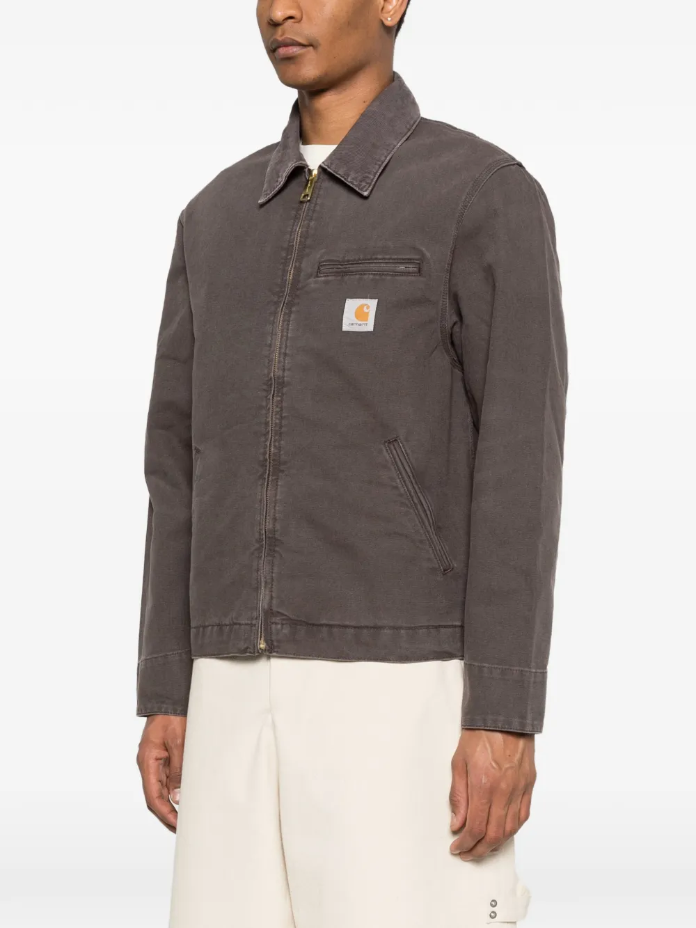 Brown jacket worn by a person, showing the jacket's fit