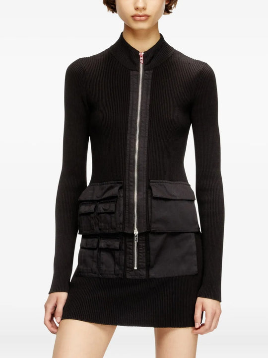 Black knitwear worn by a person, showing the knitwear's fit