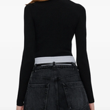 Black top worn by a person, showing the top fit