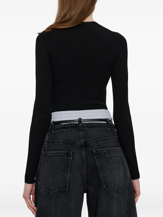 Black top worn by a person, showing the top fit