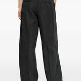 black pants worn by a person, showing the pants fit