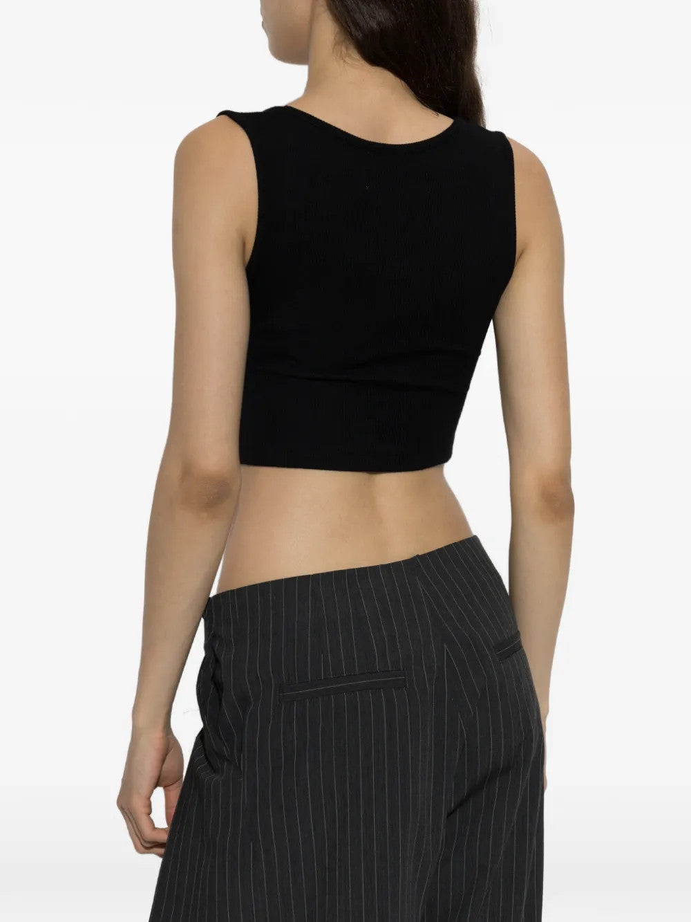 Black top worn by a person, showing the top fit