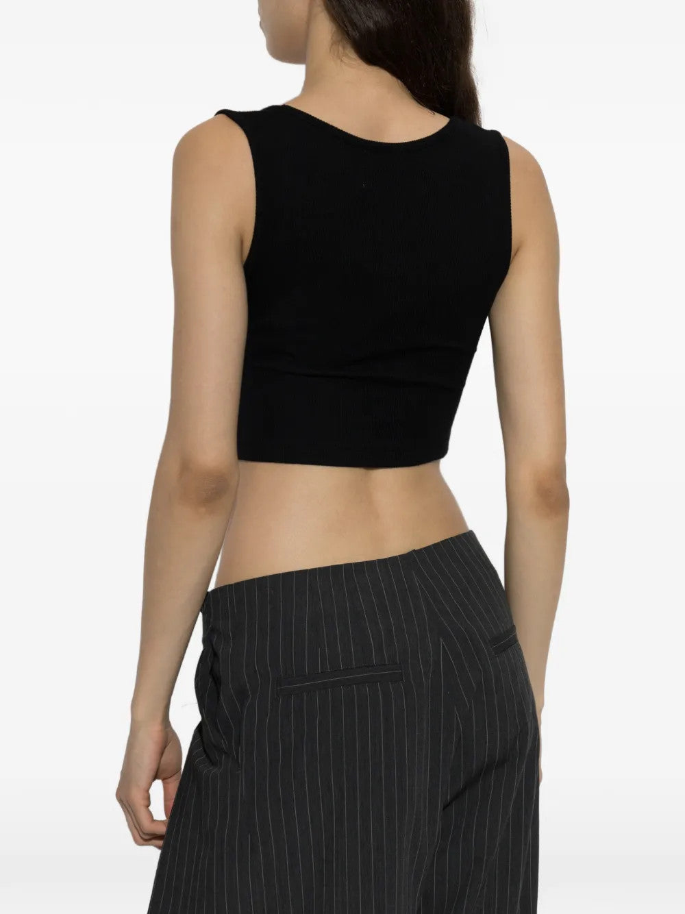 Black top worn by a person, showing the top fit