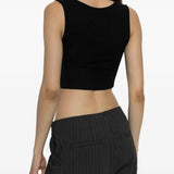 Black top worn by a person, showing the top fit