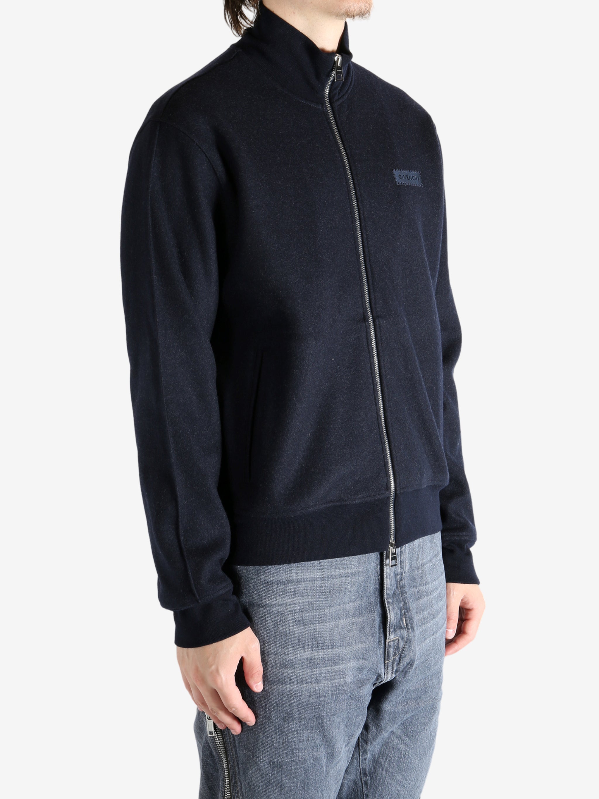 Navy coat worn by a person, showing the coat's fit