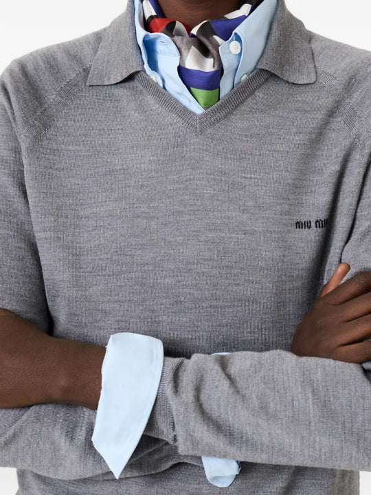 Close up of grey knitwear, showing texture of the wool fabric