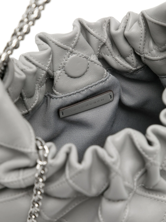 Close up of grey bag, showing texture of the leather fabric