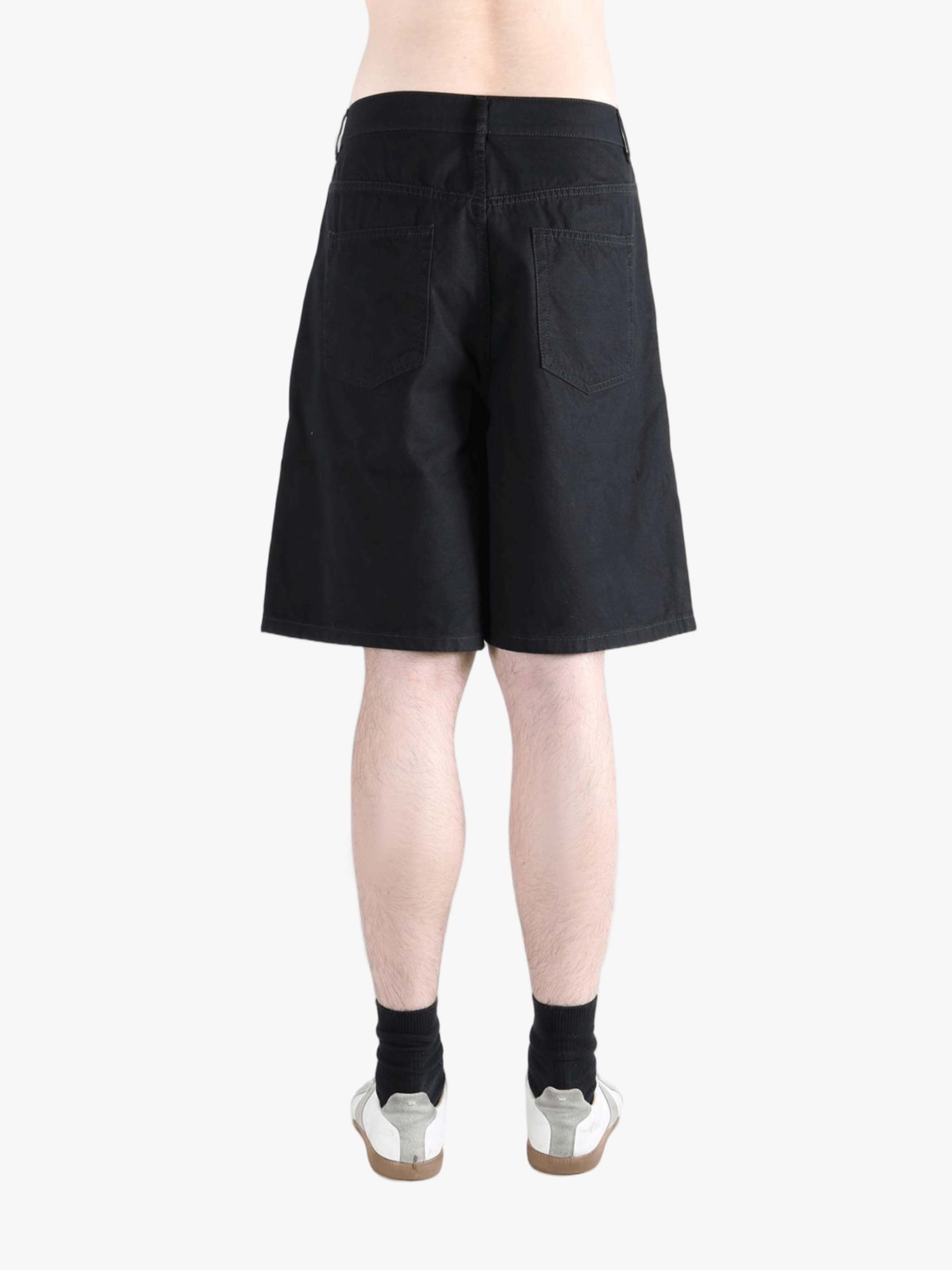 Black short worn by a person, showing the cotton fit