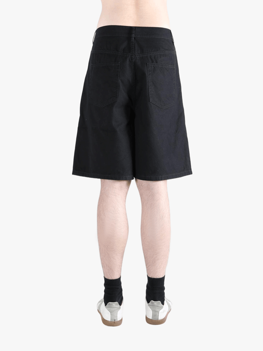 Black short worn by a person, showing the cotton fit