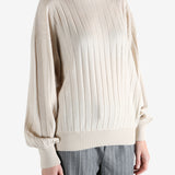 Grey knitwear worn by a person, showing the knitwear fit