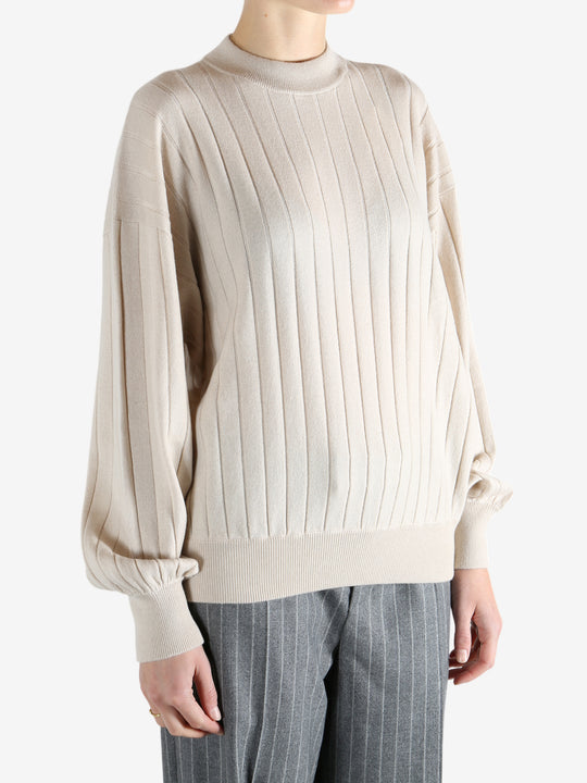 Grey knitwear worn by a person, showing the knitwear fit