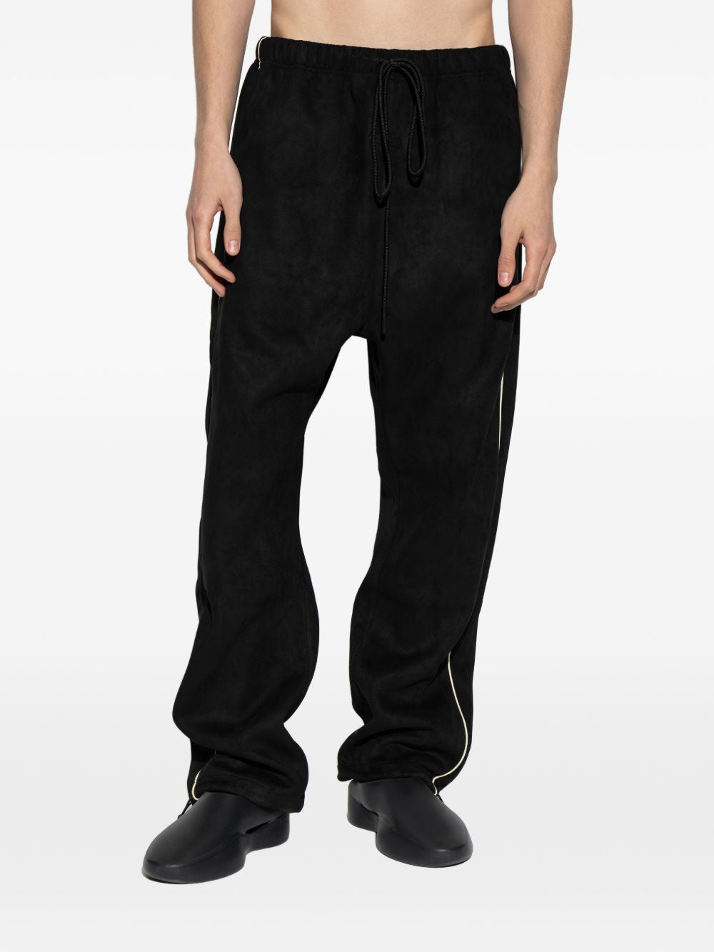 Black pants worn by a person, showing the pants' fit