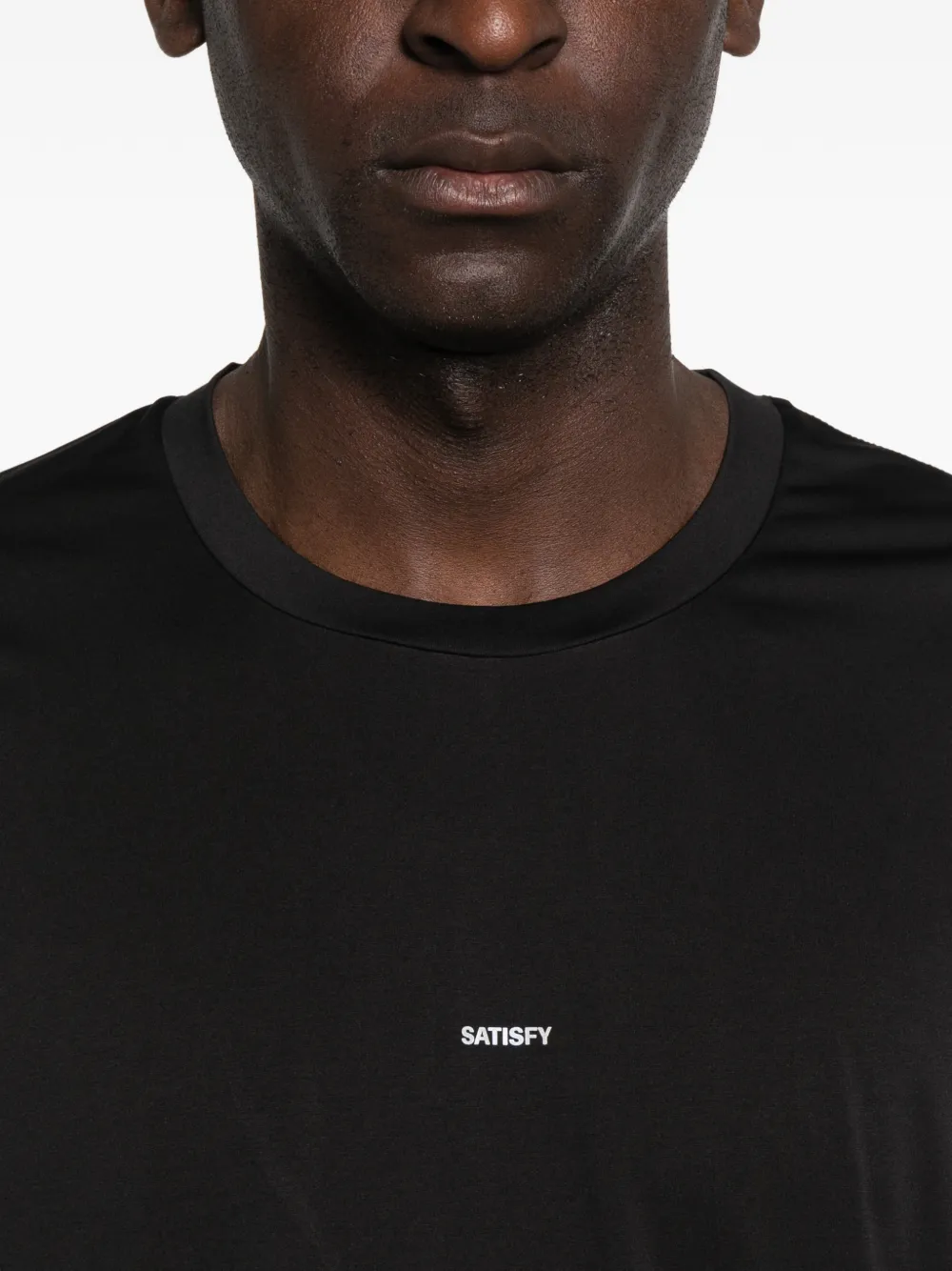 Black t-shirt worn by a person, showing the t-shirt fit