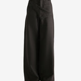 Brown pants worn by a person, showing the pants fit