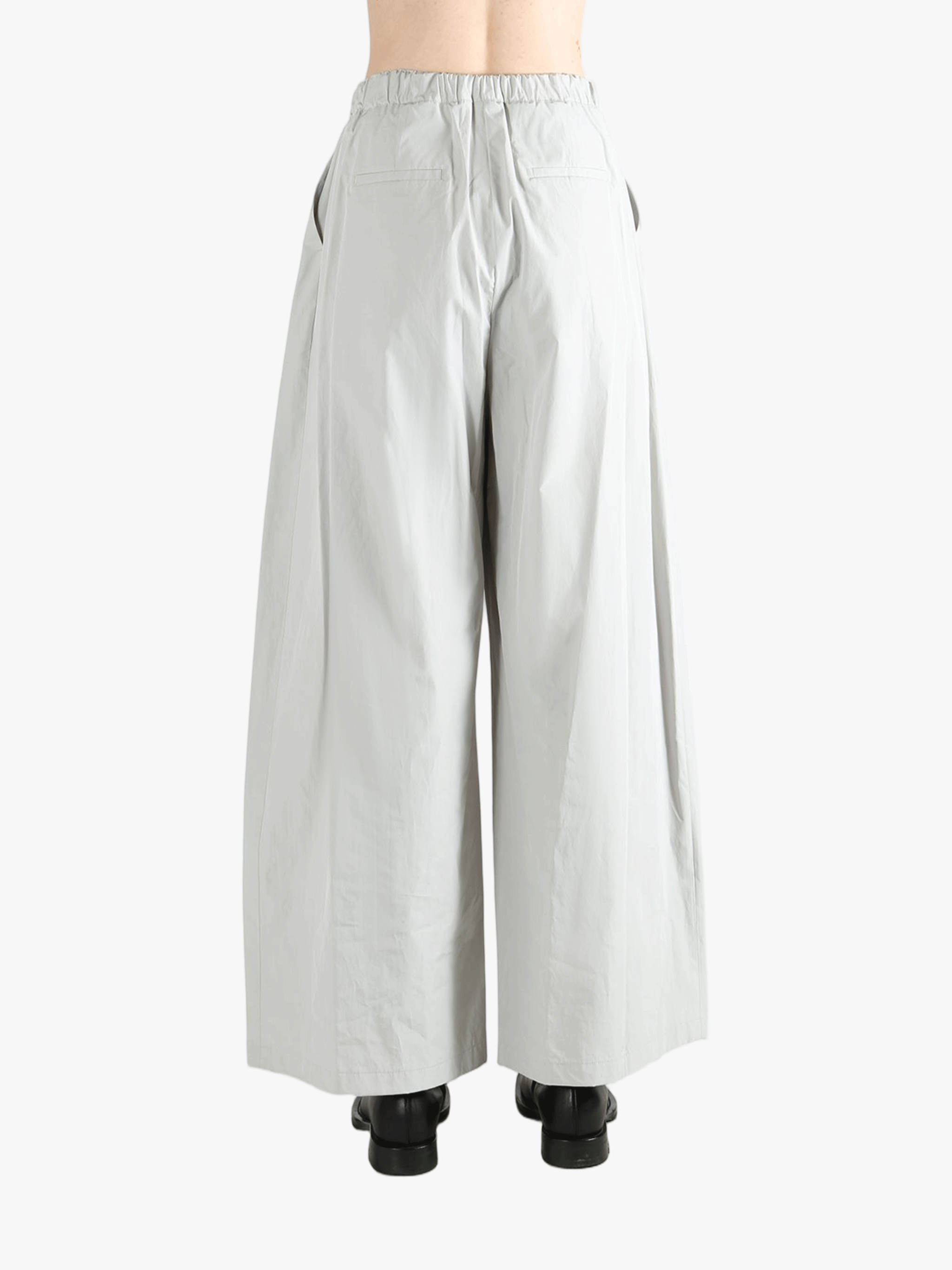 Grey pants worn by a person, showing the pants' fit