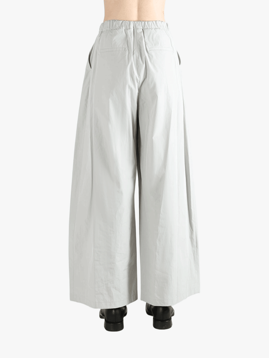 Grey pants worn by a person, showing the pants' fit