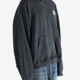 Black hoodie worn by a person, showing the hoodie's fit