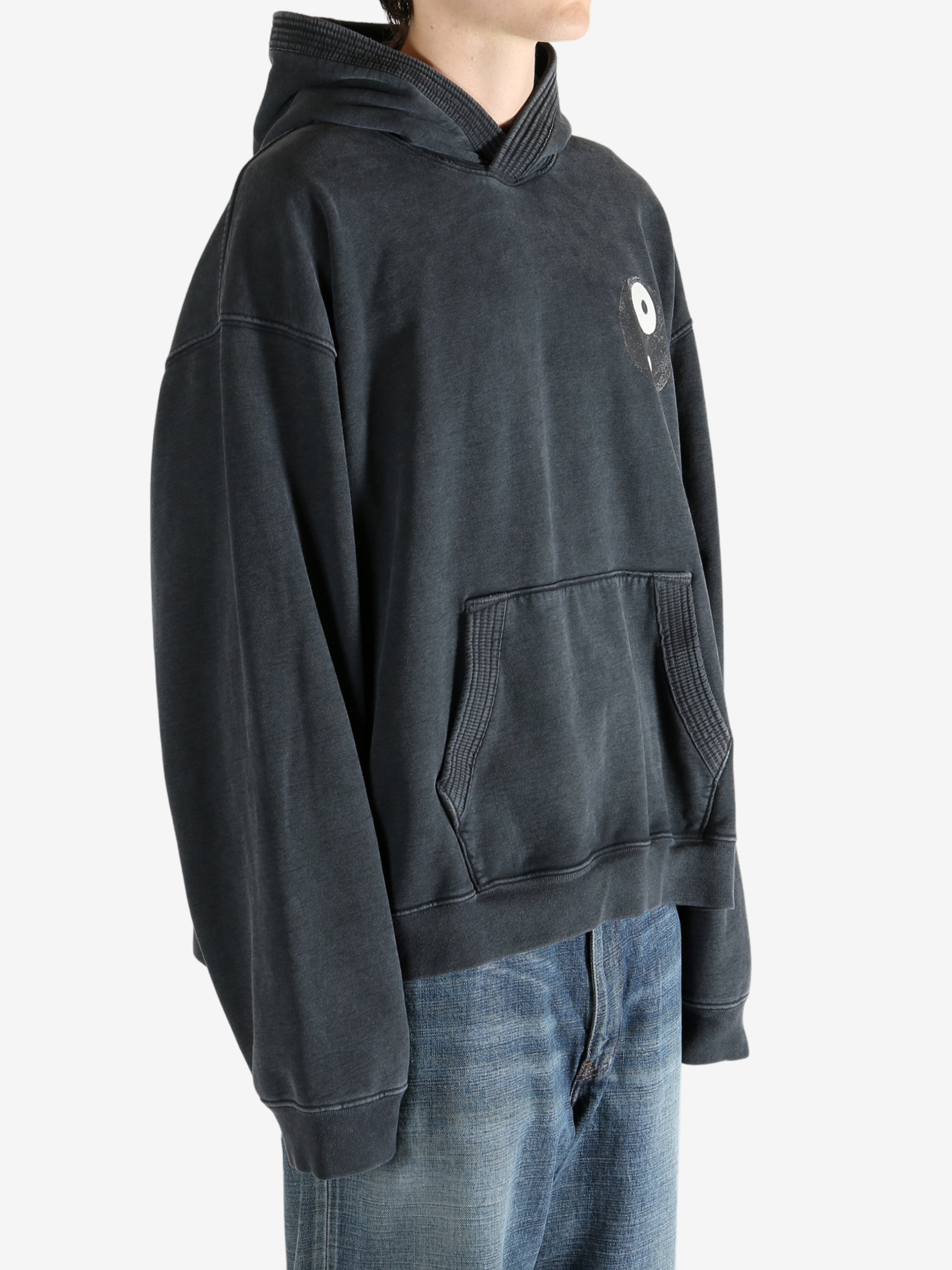 Black hoodie worn by a person, showing the hoodie's fit