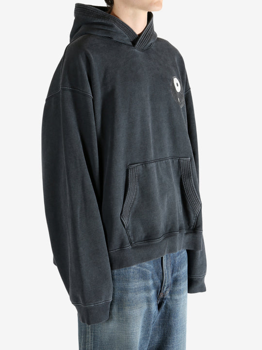 Black hoodie worn by a person, showing the hoodie's fit